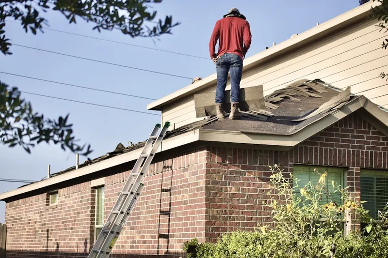 Professional roofer working on a residential roof in Beacon Woods Village